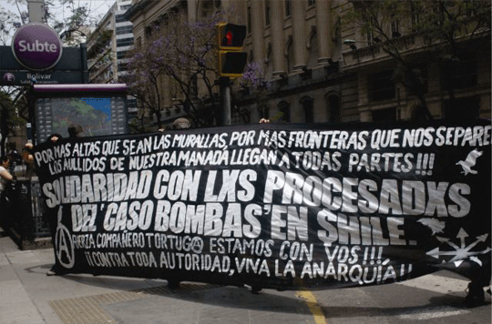 Large black-and-white banner in Spanish about "The Bombs Case"