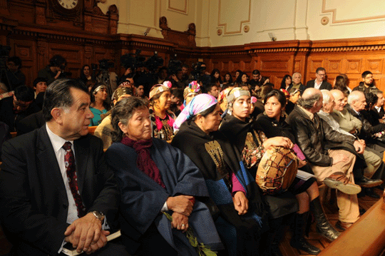Group of Mapuches sitting down in a hall