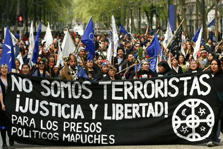 Indigenous protesters carry a banner reading: “We are not terrorists,” a response to the application of the controversial anti-terrorism law to the conflict