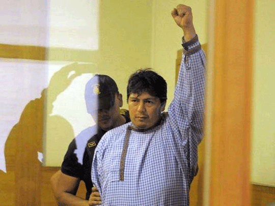 Celestino Córdova raises his fist in defiance after charges were finalized against him in the Lichsinger-Mackay case